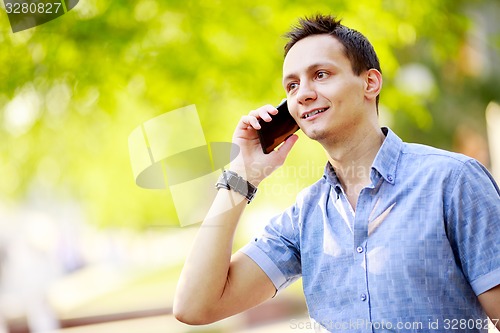 Image of handsome young man talking on the cell phone