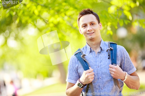 Image of bright picture of travelling student with backpack and book