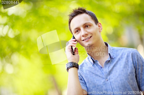 Image of handsome young man talking on the cell phone