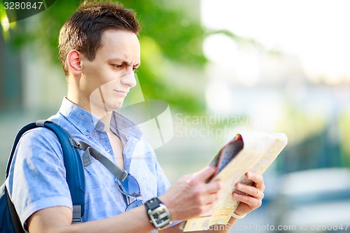 Image of Young man with map