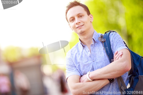 Image of bright picture of travelling student with backpack and book