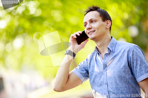 Image of handsome young man talking on the cell phone