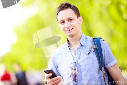 Image of Close up portrait of a young man with phone