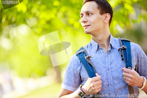 Image of bright picture of travelling student with backpack and book