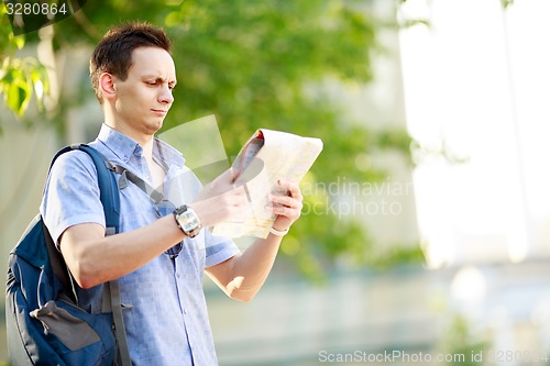 Image of Young man with map