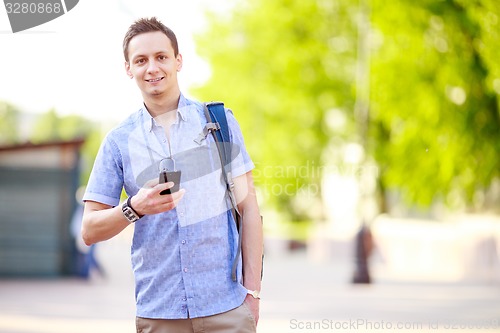 Image of Close up portrait of a young man with phone