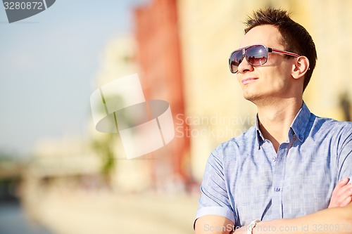 Image of Portrait of a handsome young man with sunglasses