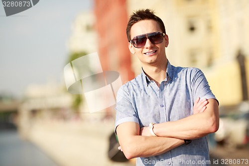 Image of Portrait of a handsome young man with sunglasses