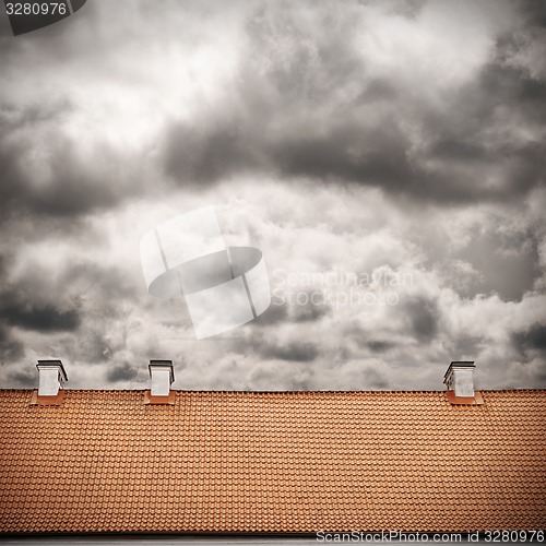 Image of stormy sky and tiled roof top