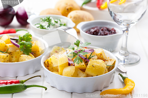 Image of Baked potatoes with chutney and sour cream