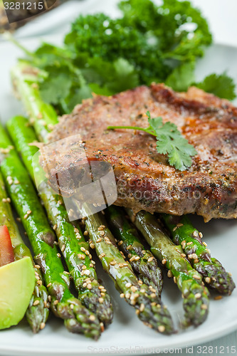 Image of Glazed green asparagus with grilled pork chop