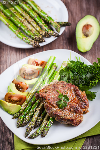 Image of Glazed green asparagus with grilled pork chop