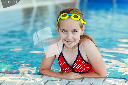 Image of Girl with goggles in swimming pool