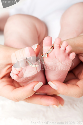 Image of Baby feet with wedding rings