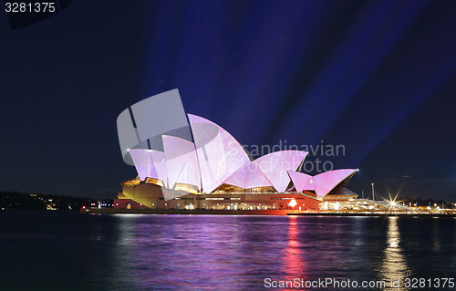 Image of Light beams project soft pastel colours onto Sydney Opera House