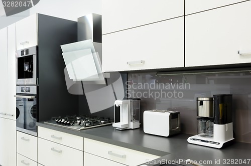 Image of Modern white kitchen, clean interior design