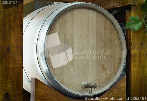 Image of Wooden oak barrel wine,  with metal crane. .