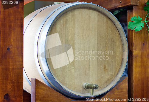 Image of Wooden oak barrel wine,  with metal crane. .