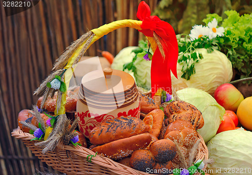 Image of Basket of bread, decorated with ribbons, and vegetables