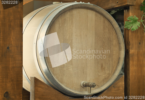 Image of Wooden oak barrel wine,  with metal crane. .