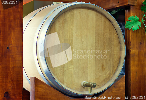 Image of Wooden oak barrel wine,  with metal crane. .