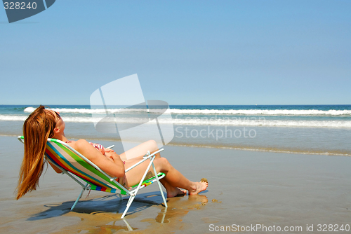 Image of Woman relaxing on beach