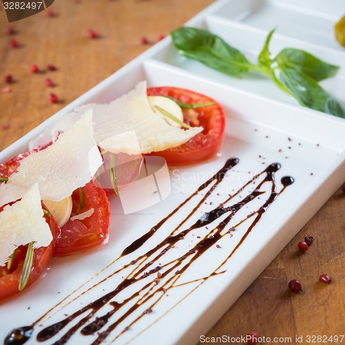 Image of Fresh tomatoes, basil, garlic and parmesan cheese