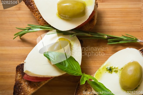 Image of Bruschetta with tomato, mozarella and olive