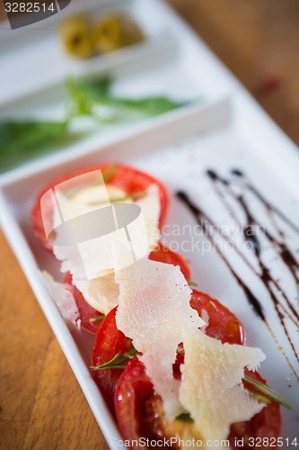 Image of Fresh tomatoes, basil, garlic and parmesan cheese