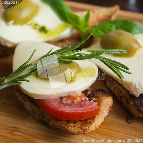 Image of Bruschetta with tomato, mozarella and olive