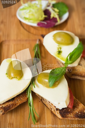 Image of Bruschetta with tomato, mozarella and olive