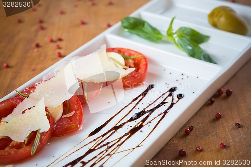 Image of Fresh tomatoes, basil, garlic and parmesan cheese