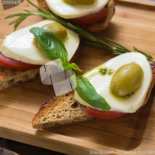 Image of Bruschetta with tomato, mozarella and olive