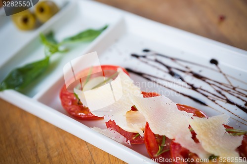 Image of Fresh tomatoes, basil, garlic and parmesan cheese
