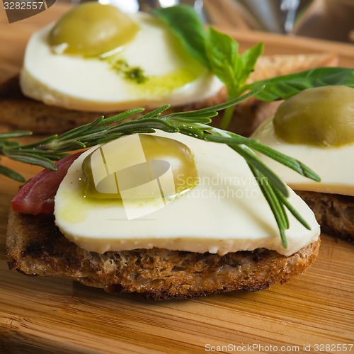 Image of Bruschetta with tomato, mozarella and olive