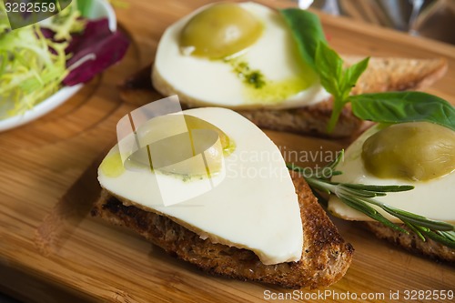 Image of Bruschetta with tomato, mozarella and olive