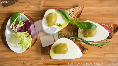 Image of Bruschetta with tomato, mozarella and olive