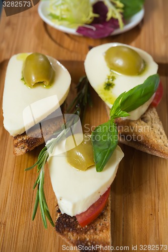 Image of Bruschetta with tomato, mozarella and olive