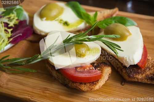 Image of Bruschetta with tomato, mozarella and olive