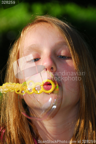 Image of Young girl soap bubbles