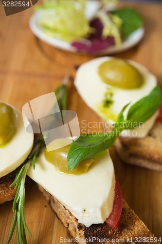 Image of Bruschetta with tomato, mozarella and olive