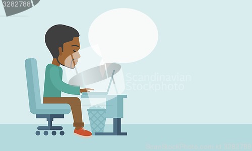 Image of African sitting infront his computer.