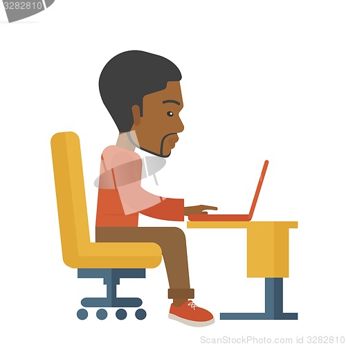 Image of African sitting infront his computer.