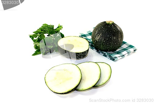 Image of rotund raw zucchini on a napkin