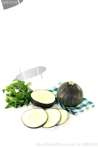 Image of rotund raw zucchini on a green napkin