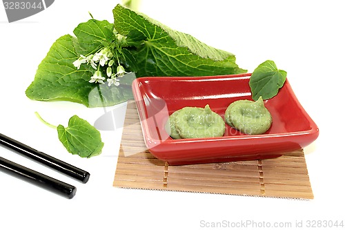 Image of Wasabi with Chopsticks, leaves and blossoms