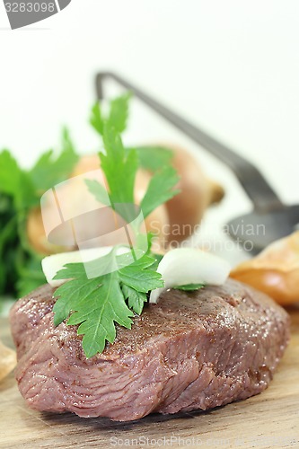 Image of Ostrich steak with onions