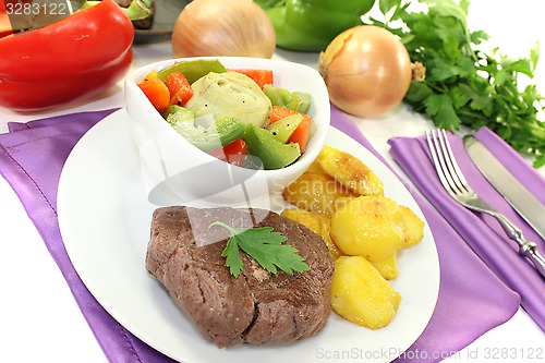 Image of Ostrich steaks with baked potatoes