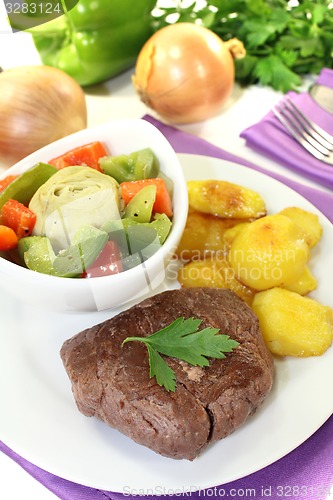 Image of Ostrich steak with crispy baked potatoes