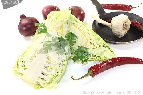 Image of sweetheart cabbage with onions in a pan